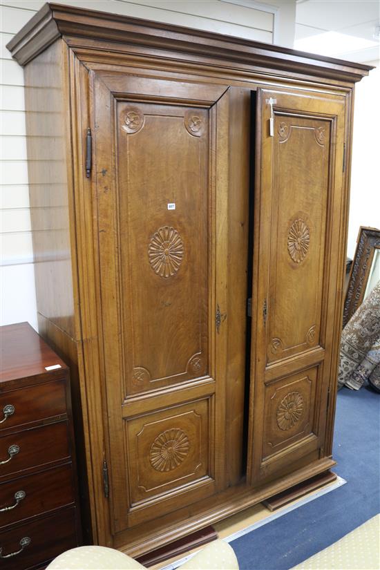 A 19th century French provincial walnut armoire, fitted a pair of doors carved with oval paterae W.158cm